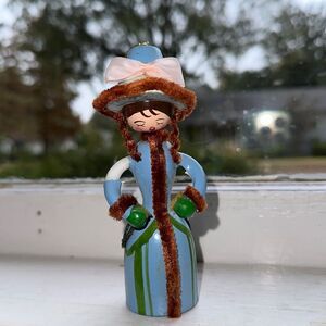 Vintage wooden old fashioned lady Christmas caroler in blue outfit ornament